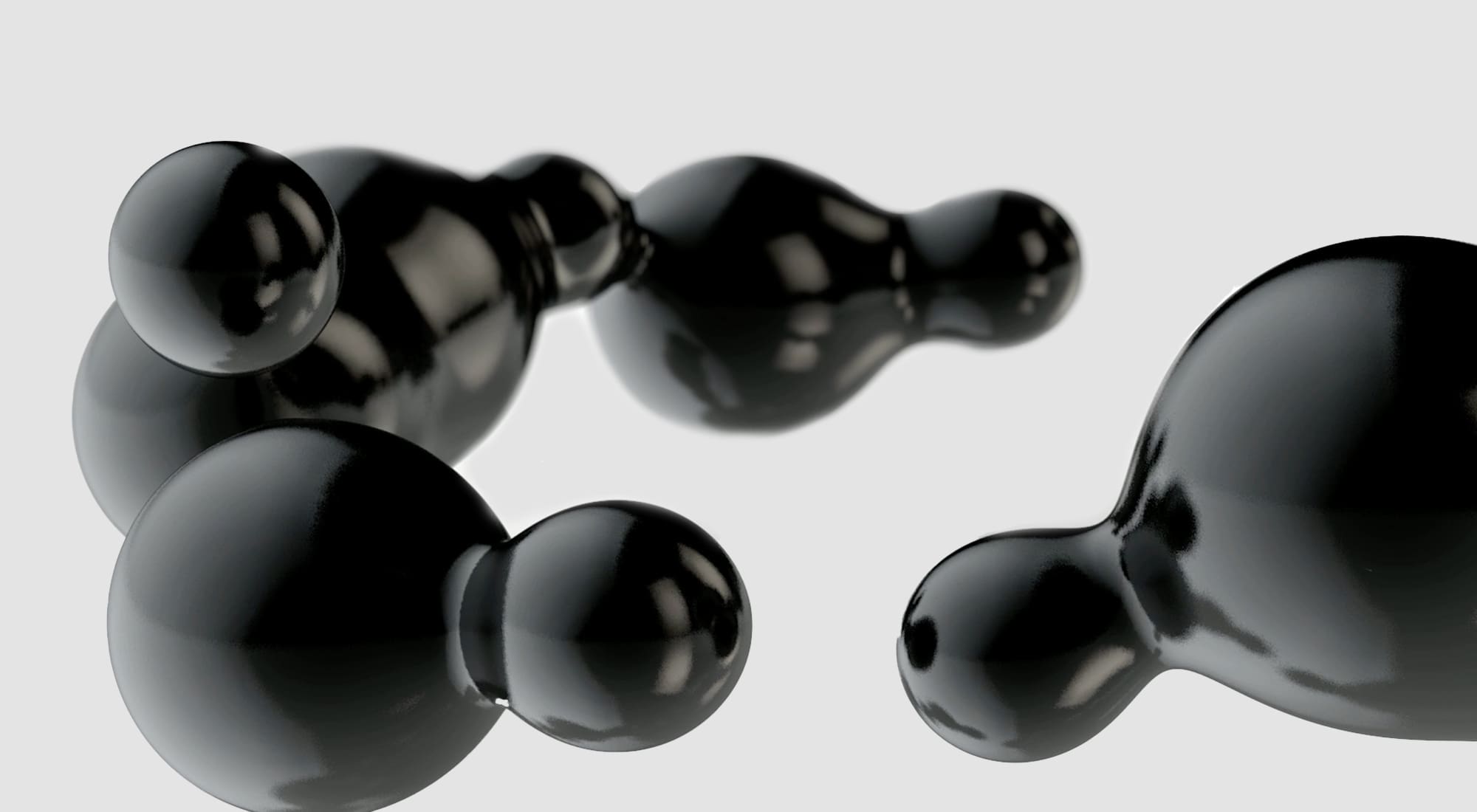 Abstract image showing glossy black interconnected spheres on a light grey background, creating a smooth, fluid, and reflective surface effect.