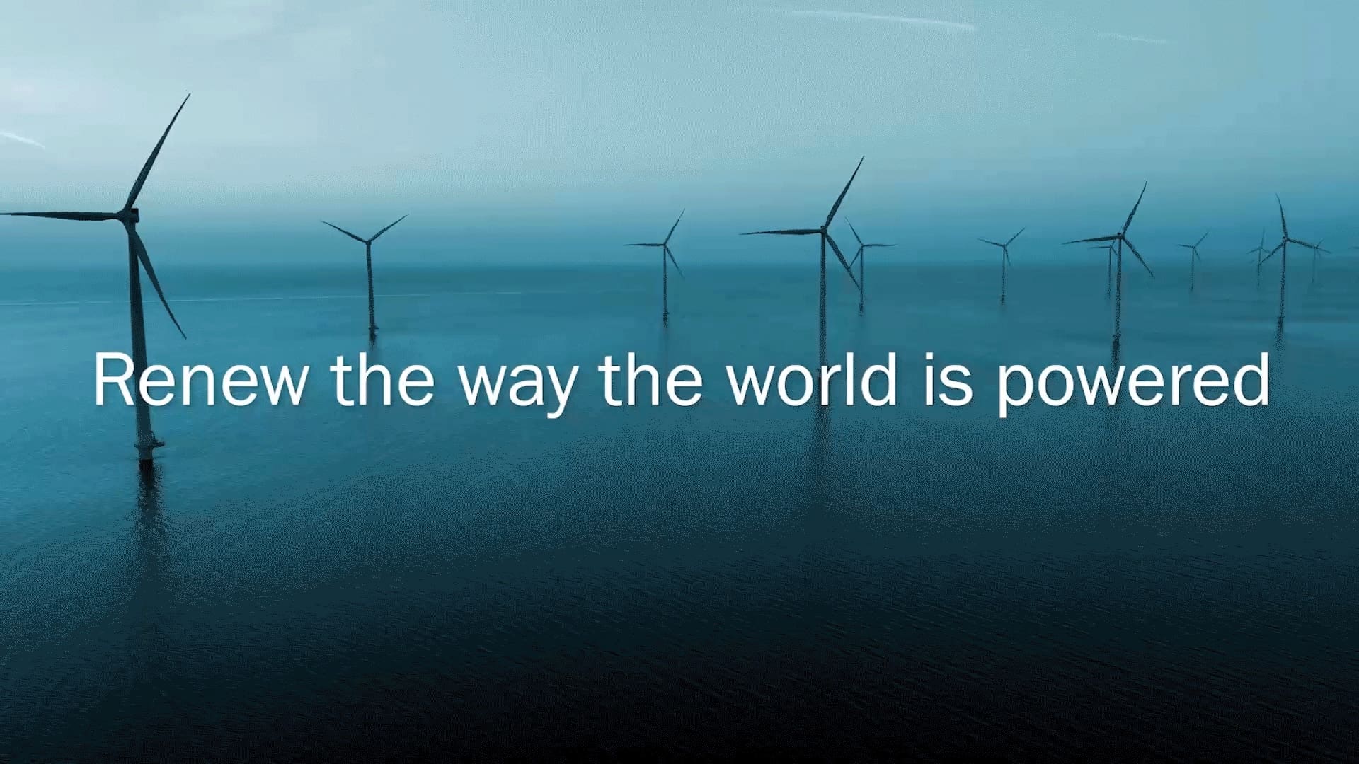 Offshore wind turbines standing in calm blue ocean waters under an overcast sky, with the headline “Renew the way the world is powered” displayed prominently across the center. Corporate banner for Statkraft highlighting renewable energy and offshore wind power.