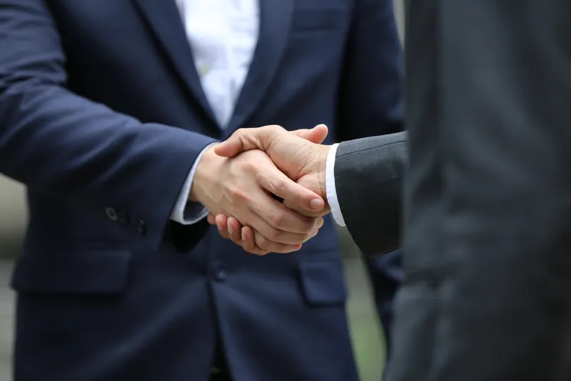 businessmen shaking hands for closed deal