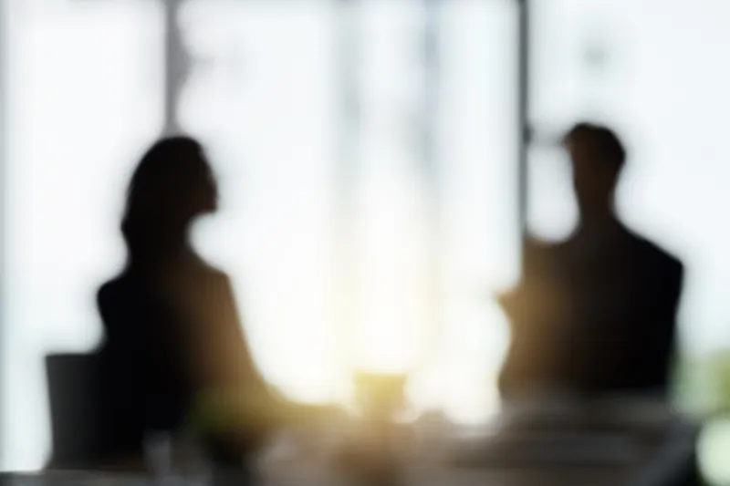 Silhouetted Figures at a brand consultancy Meeting