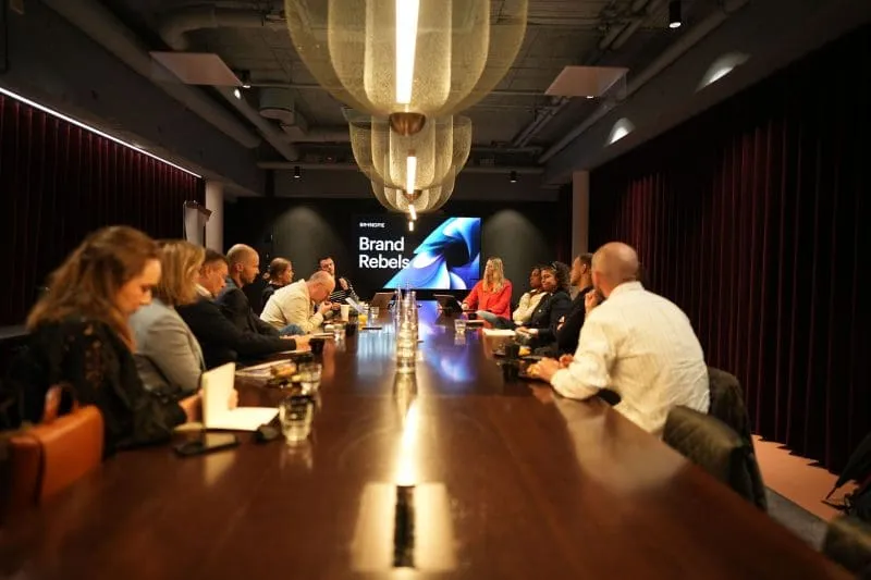 Brand Rebels roundtable in Oslo, with senior leaders gathered around a long boardroom table discussing AI, brand and distinctiveness.